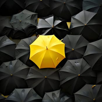 A yellow umbrella stands out among black umbrellas for rain protection and shade