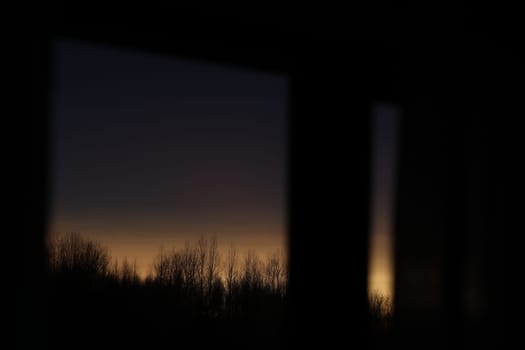 Sunset clouds mirrored in the window. Nature sunset sky backdrop. Blurry abstract sunrise background.