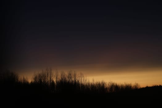 Sunset clouds mirrored in the window. Nature sunset sky backdrop. Blurry abstract sunrise background.