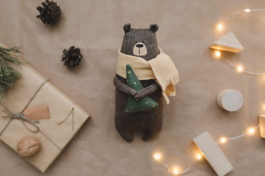 Christmas composition. Toy Teddy Bear, a gift, fir tree branches and decorations. Christmas, winter, new year concept. Flat lay, top view, copy space.