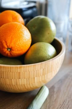 wooden bowl with green grapefruit and oranges on the table healthy fibre pomelo vitamin c immune. High quality photo