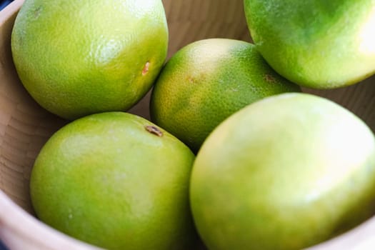 wooden bowl with green grapefruit healthy fibre pomelo vitamin c immune juicy citrus. High quality photo