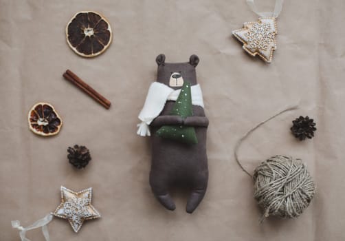 Christmas composition. Toy Teddy Bear, a gift, fir tree branches and decorations. Christmas, winter, new year concept. Flat lay, top view, copy space.