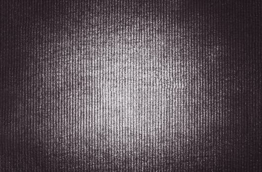A brown image of convex vertical stripes with an illuminated center and a shadow at the edges