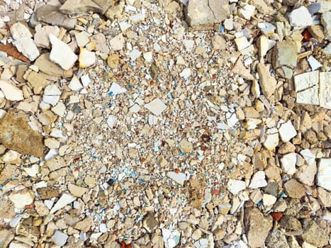 The ground is covered with a mix of crushed materials displaying a range of colors and textures, perfect for creative projects or landscaping.