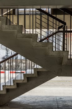 Bangkok, Thailand - 27 Feb 2023 - Side view of Old concrete staircases with railings pattern in the old apartment building architecture. which are deteriorated over time, Space for text, Selective Focus.