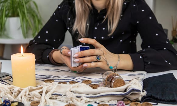 A fortune teller reads with tarot cards. Selective focus. Woman.