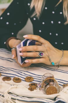 A fortune teller reads with tarot cards. Selective focus. Woman.