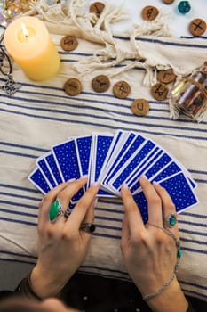 A fortune teller reads with tarot cards. Selective focus. Woman.