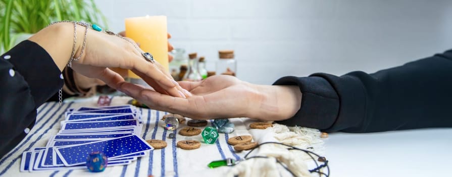 A fortune teller reads with tarot cards. Selective focus. Woman.