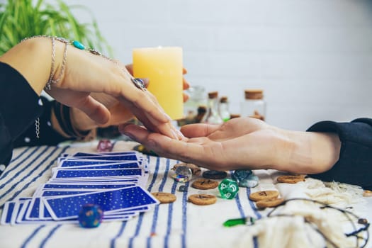 A fortune teller reads with tarot cards. Selective focus. Woman.