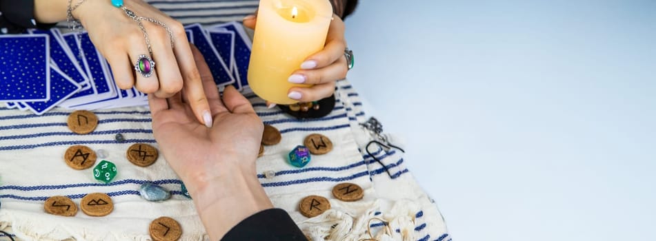 A fortune teller reads with tarot cards. Selective focus. Woman.