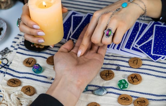 A fortune teller reads with tarot cards. Selective focus. Woman.