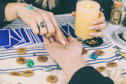 A fortune teller reads with tarot cards. Selective focus. Woman.