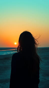 A serene silhouette of a woman standing by the beach, gazing at a vibrant sunset, reflecting tranquility and solitude.