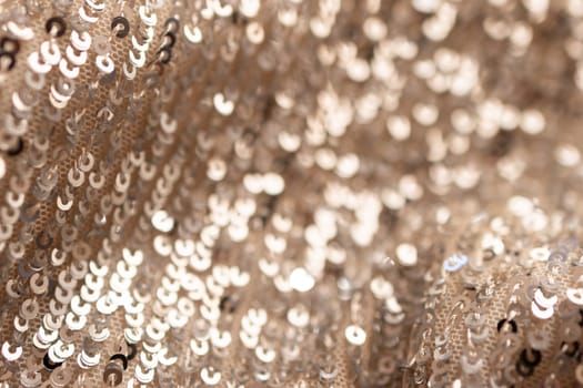 Golden shiny material background. Pure gold wire mesh. Chrome bronze Fabric waves. Horizontal blurred golden surface.Metallic shines and shadows.