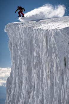 Mountain descent: snowboarder carving through fresh powder in winter mountains, capturing essence of outdoor sports and exhilaration of gliding down pristine slopes under sky
