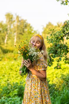 Woman with medicinal herbs in a meadow. Selective focus. nature.
