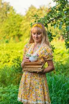 Woman with medicinal herbs in a meadow. Selective focus. nature.