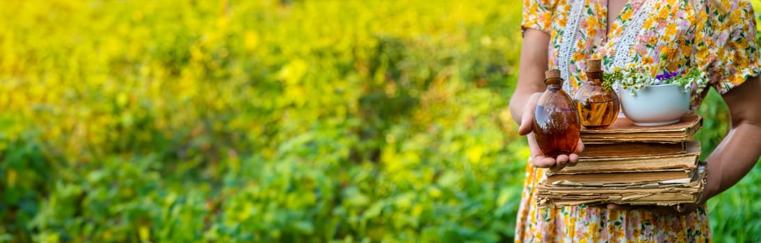 Woman with medicinal herbs in a meadow. Selective focus. nature.