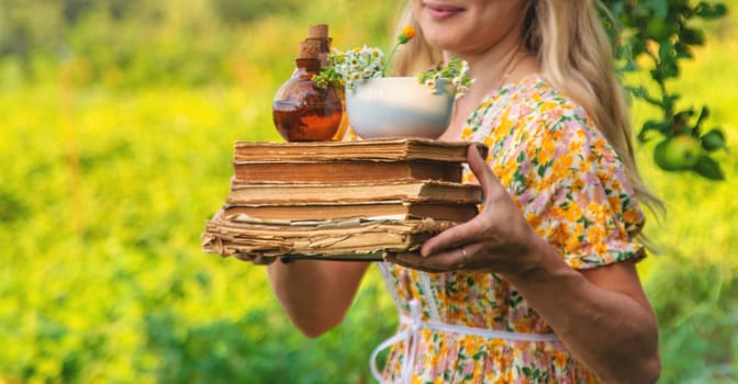Woman with medicinal herbs in a meadow. Selective focus. nature.