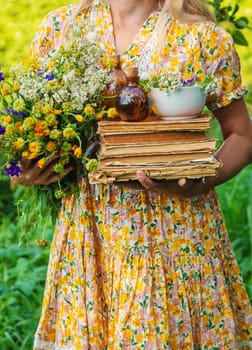 Woman with medicinal herbs in a meadow. Selective focus. nature.