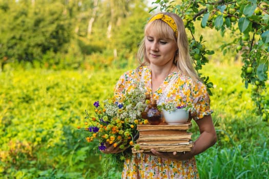 Woman with medicinal herbs in a meadow. Selective focus. nature.