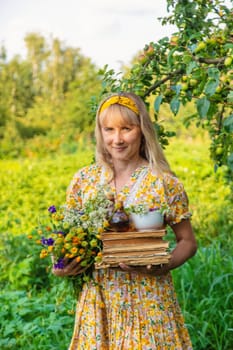 Woman with medicinal herbs in a meadow. Selective focus. nature.