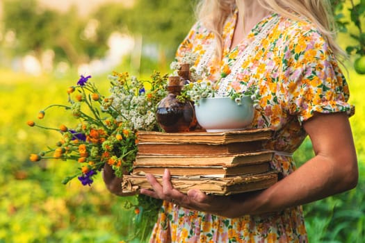 Woman with medicinal herbs in a meadow. Selective focus. nature.