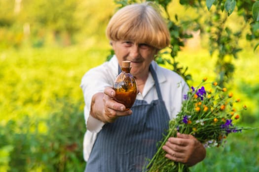 Woman with medicinal herbs in a meadow. Selective focus. nature.