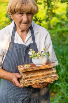 Woman with medicinal herbs in a meadow. Selective focus. nature.
