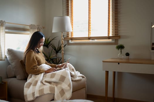 Young woman enjoying work from home in a warm and cozy space.