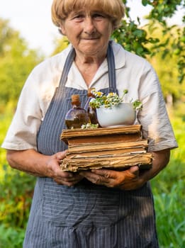 Woman with medicinal herbs in a meadow. Selective focus. nature.