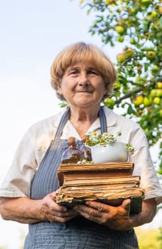 Woman with medicinal herbs in a meadow. Selective focus. nature.
