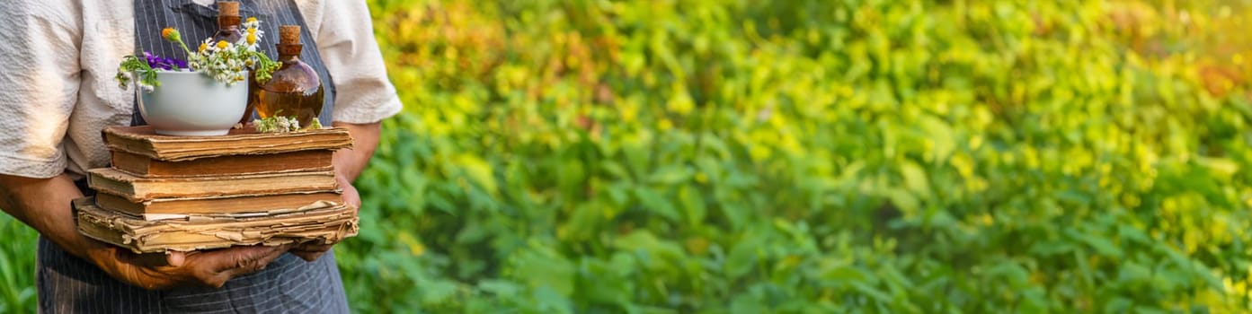 Woman with medicinal herbs in a meadow. Selective focus. nature.