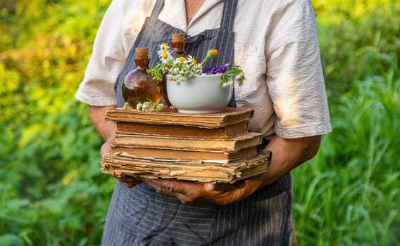 Woman with medicinal herbs in a meadow. Selective focus. nature.