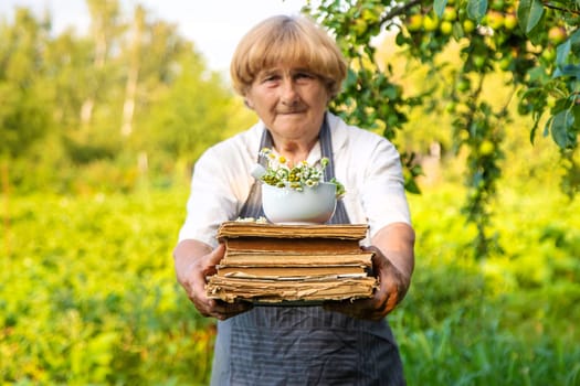 Woman with medicinal herbs in a meadow. Selective focus. nature.