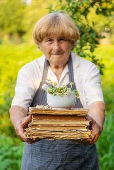 Woman with medicinal herbs in a meadow. Selective focus. nature.