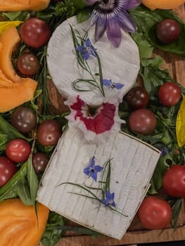 Selection of French cheeses from Normandy, AOP, Livarot, Neufchatel, Pont l'eveque, Rye bread, figs, walnuts, grapes, elderberry gelee. High quality photo