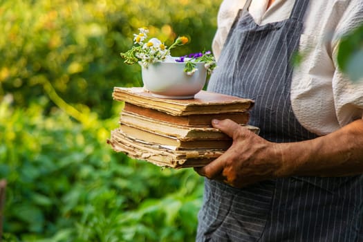 Woman with medicinal herbs in a meadow. Selective focus. nature.