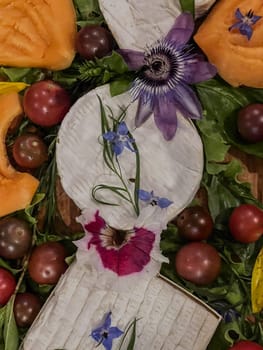 Selection of French cheeses from Normandy, AOP, Livarot, Neufchatel, Pont l'eveque, Rye bread, figs, walnuts, grapes, elderberry gelee. High quality photo