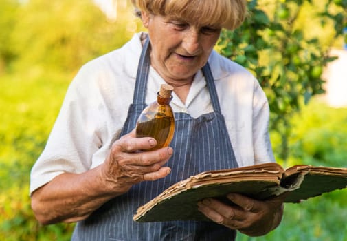 Woman with medicinal herbs in a meadow. Selective focus. nature.