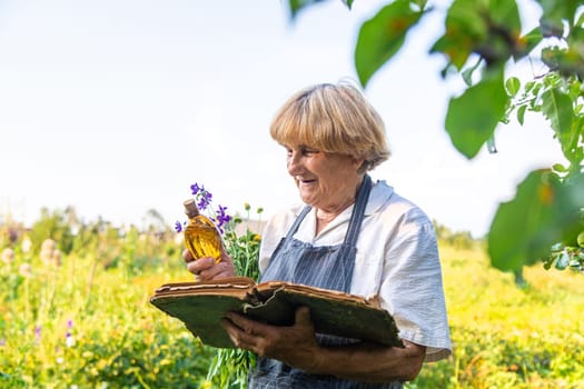 Woman with medicinal herbs in a meadow. Selective focus. nature.