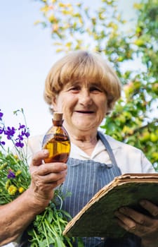 Woman with medicinal herbs in a meadow. Selective focus. nature.