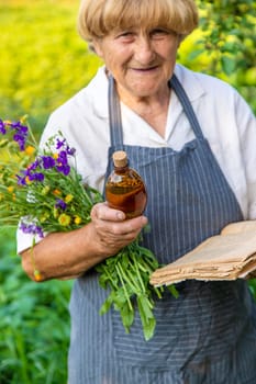 Woman with medicinal herbs in a meadow. Selective focus. nature.