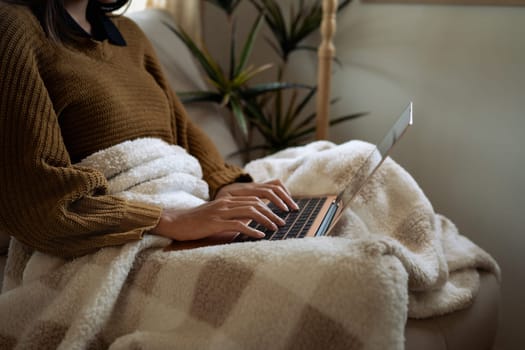 Young woman enjoying work from home in a warm and cozy space.
