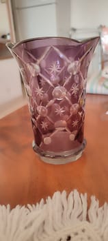 beautiful pink purple glass vase on table, object home , bohemia pattern ornament. High quality photo