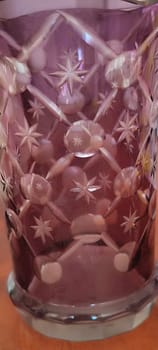 beautiful pink purple glass vase on table, object home , bohemia pattern ornament. High quality photo