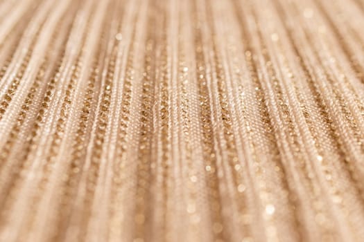 Gold glitter material background.Blurred golden background. Metallic shimmers and shadows. Used for the background of luxury goods advertisements.