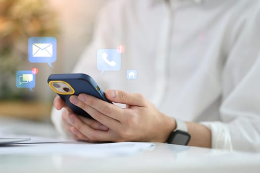 Close up of hands using smartphone with message and call notifications.